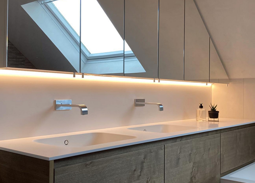 Vernieuwd sanitair met nieuw badkamermeubel in hout en met indirect licht geplaatst door Joris Nyssens Wuustwezel